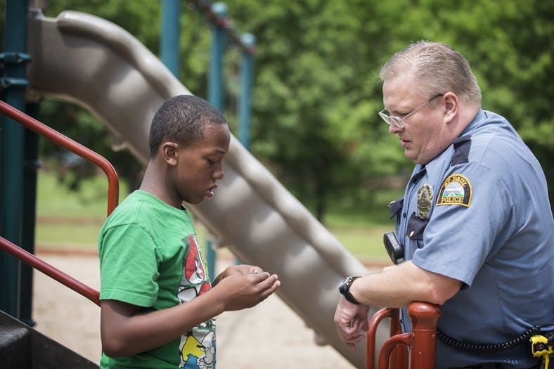 police office talks with young man with autism 